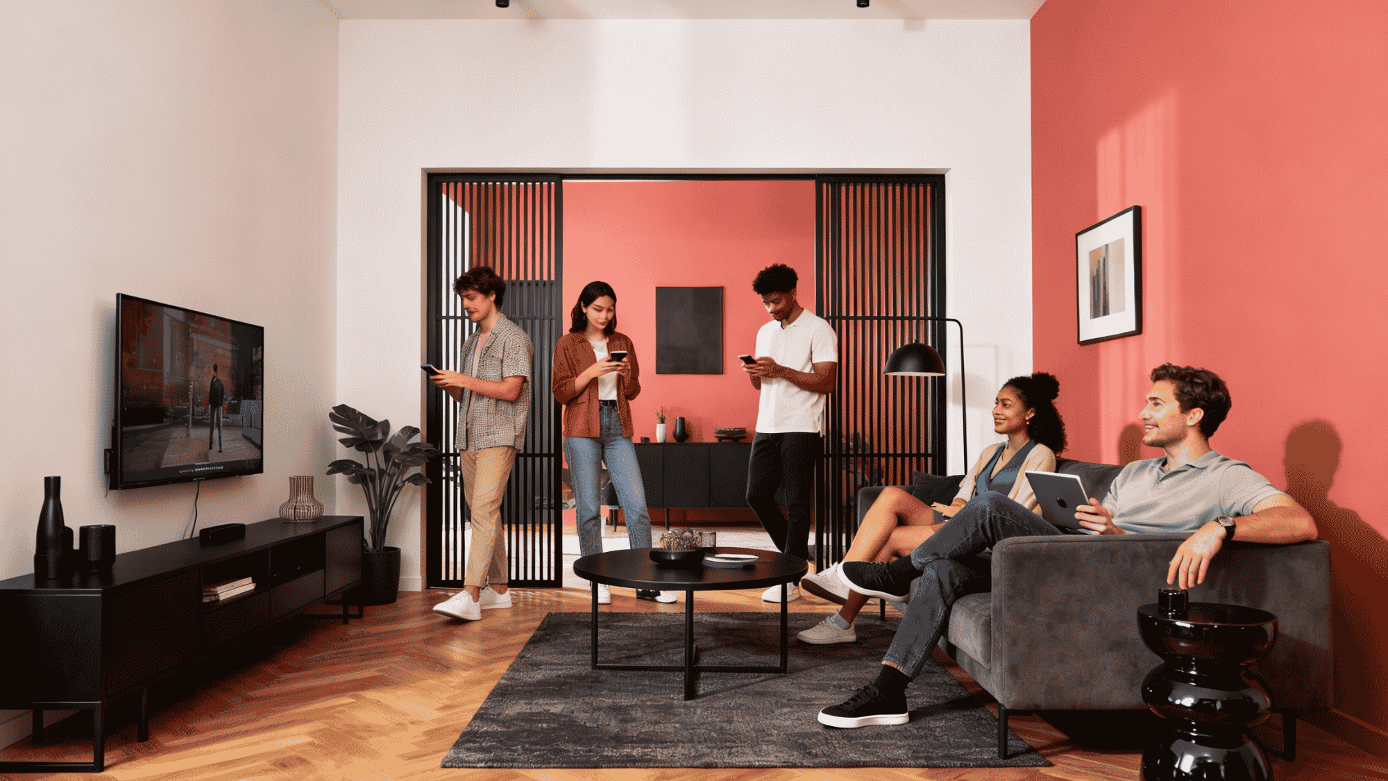 group of friends watching TV and different devices