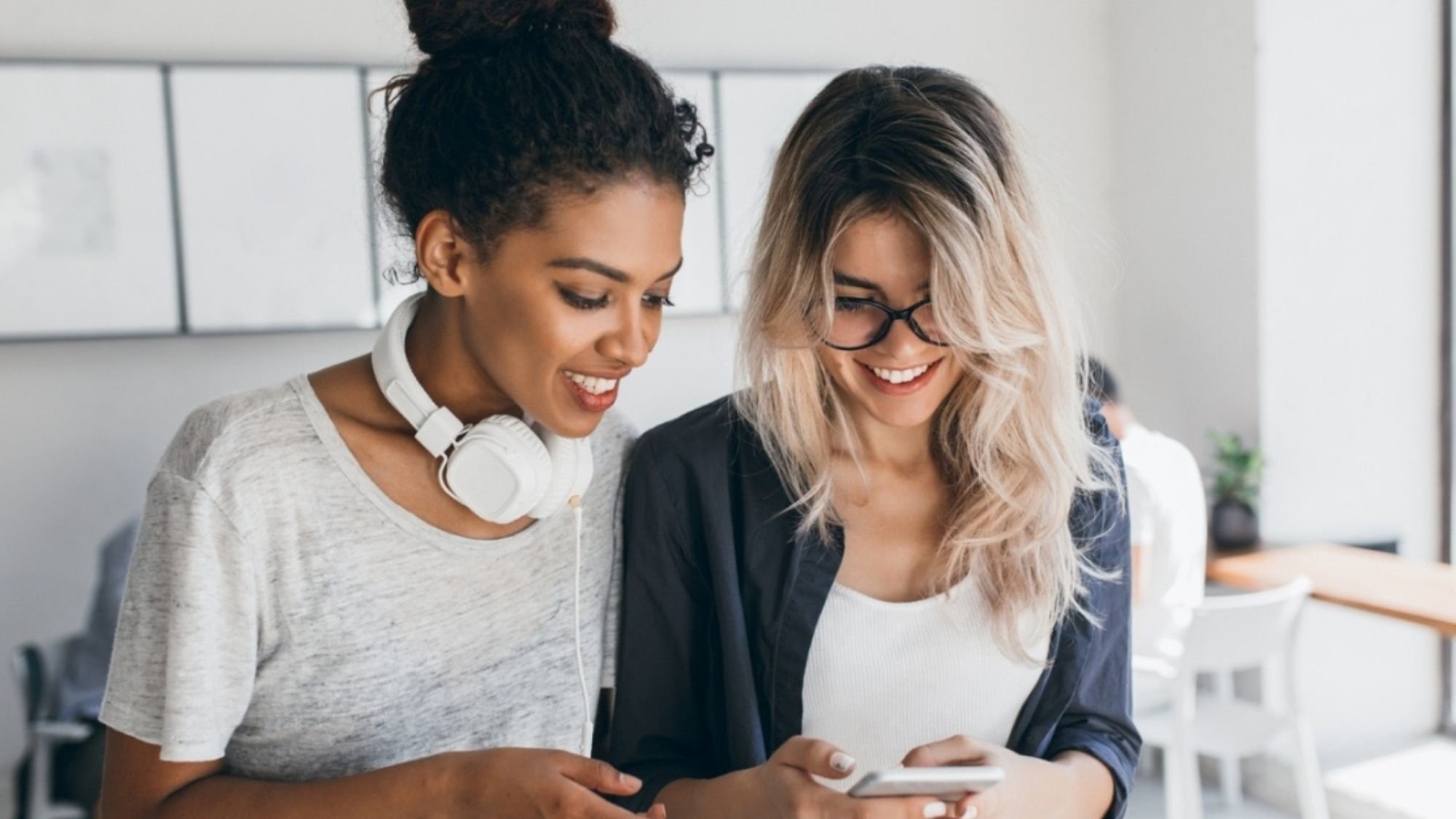 two women looking at phone